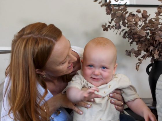 Happy woman with a baby after successfully being helped by IVF at Genea