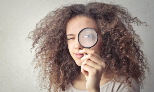 Girl with magnifying glass