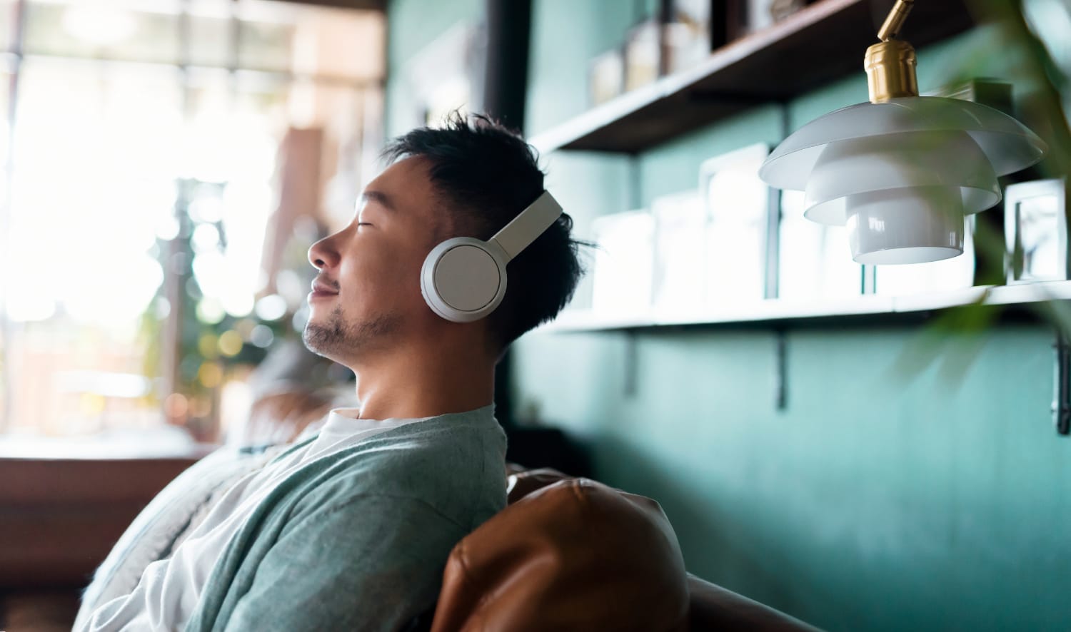 male listening to podcast on headphones